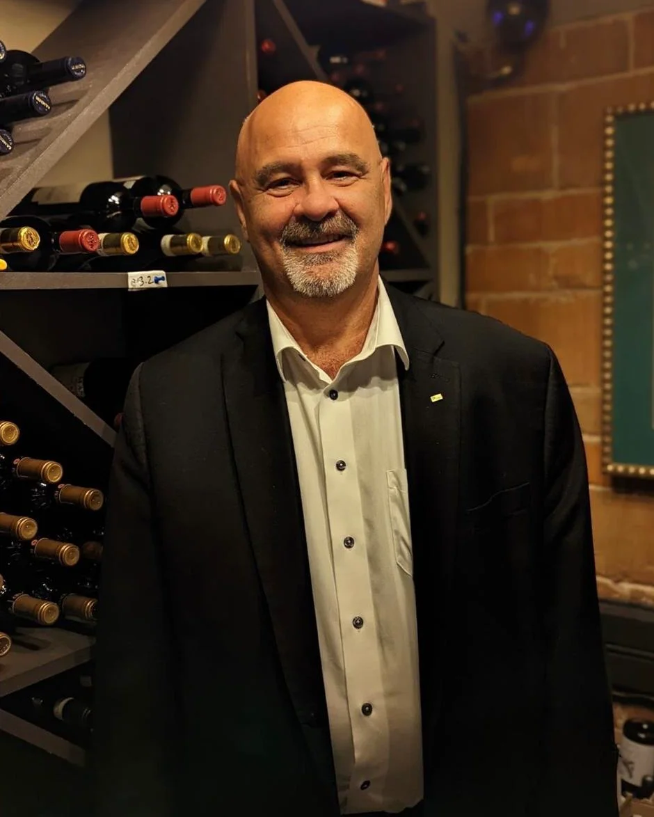 Aldo Mazzaferro standing in a restaurant wine cellar